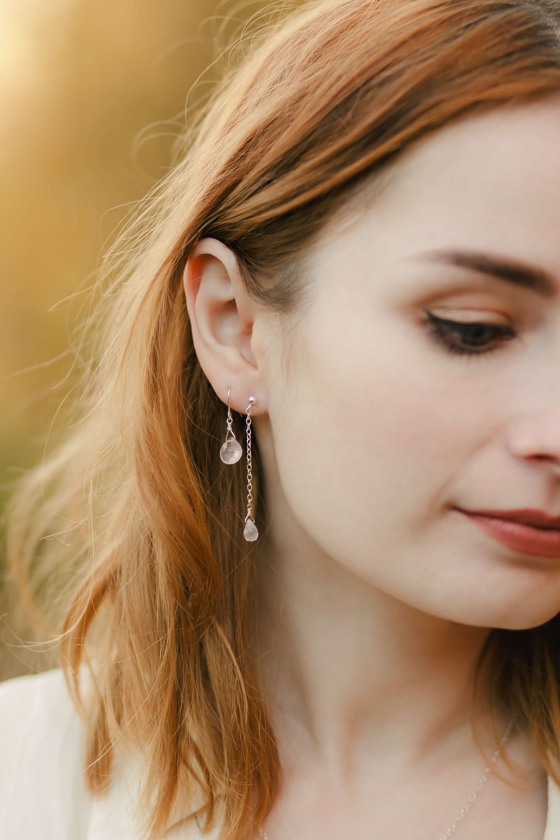Close-up of a woman wearing earrings with a blurred background