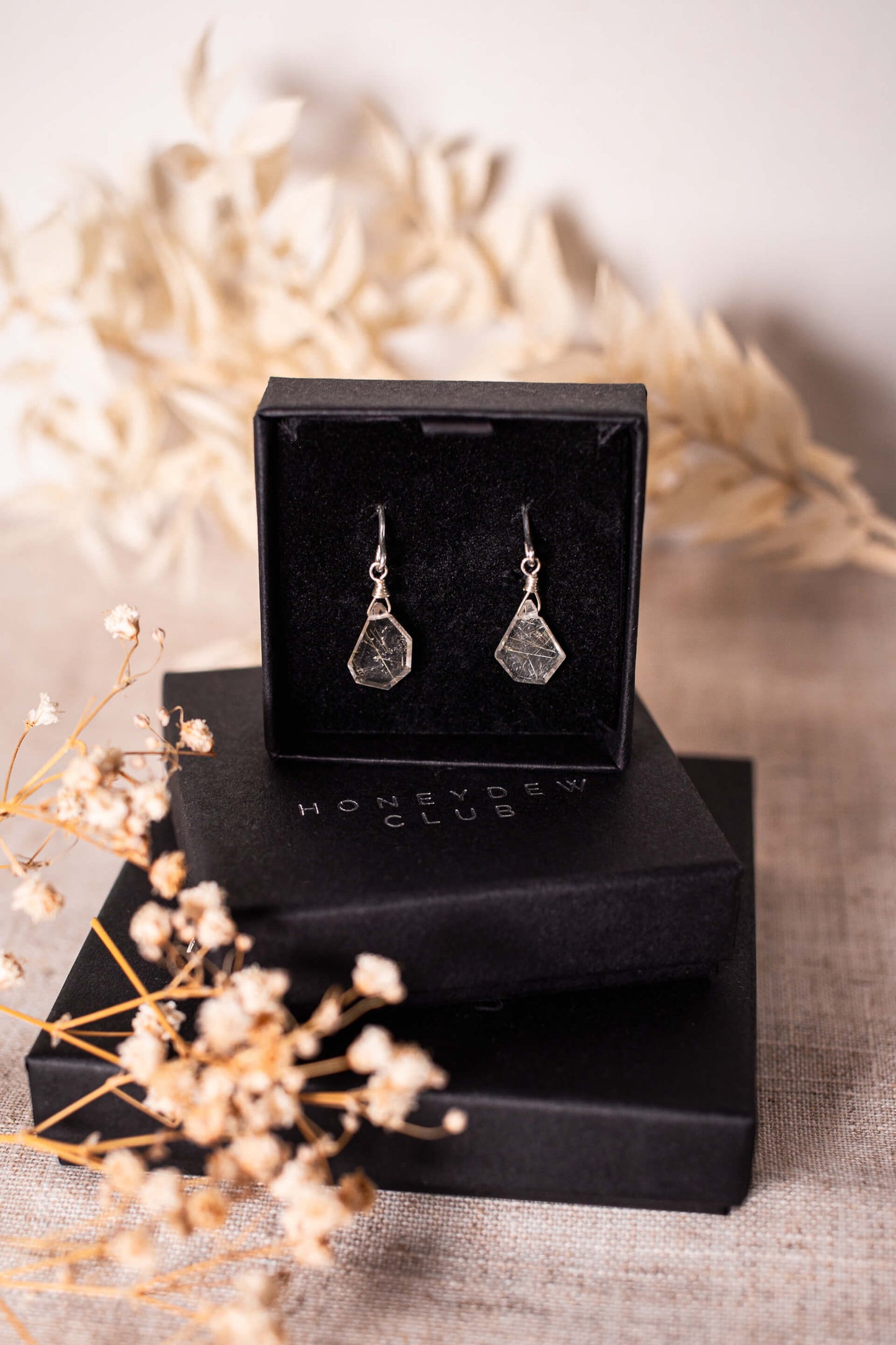 Asymmetric gemstones on sterling silver earrings in a black gift box